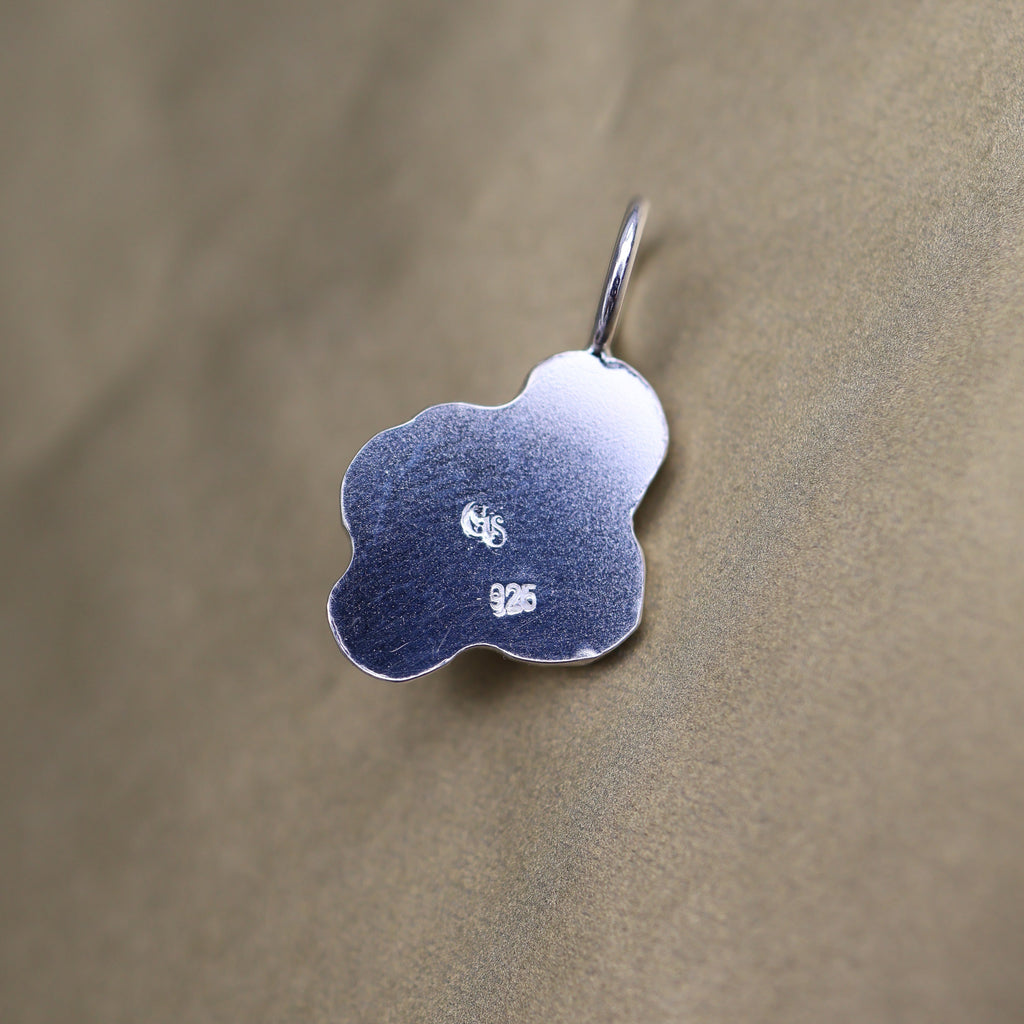 back of a silver pendant with quality and makers mark stamps