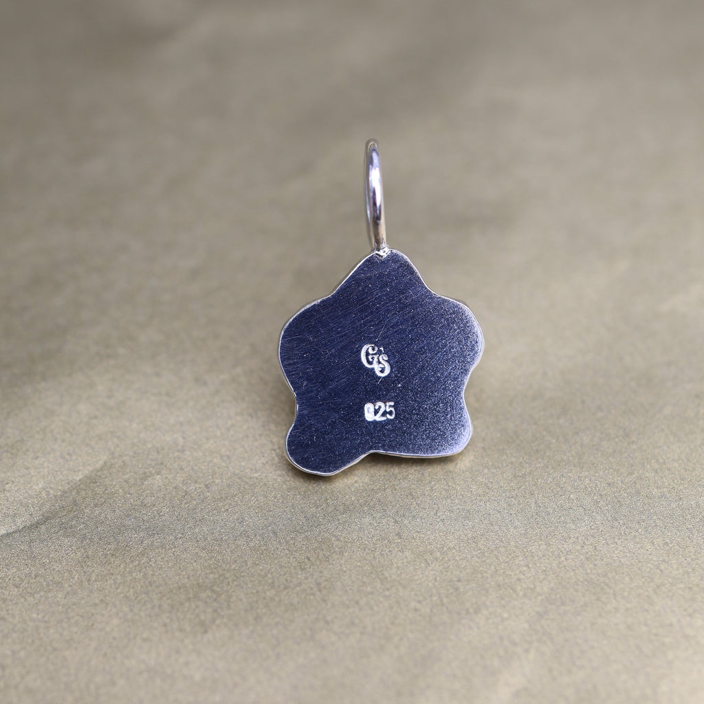 back of a sterling silver pendant showing quality and makers mark stamps