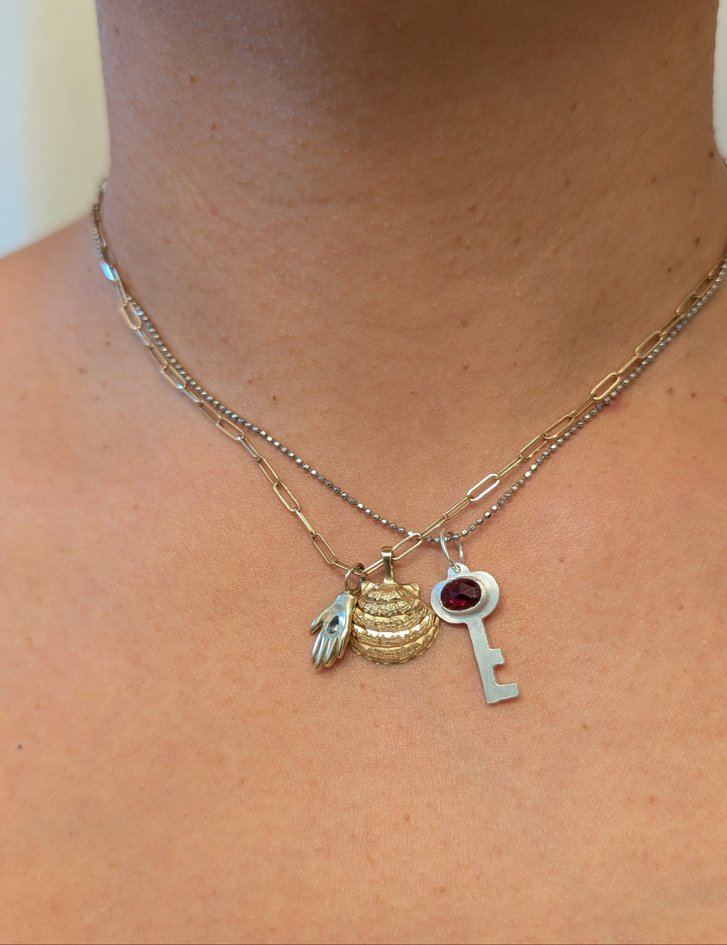 a necklace stack with 3 charms